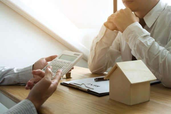 Businessmen present price contract on trading - rent a house to customers. Insurance Agent house. Business concept.